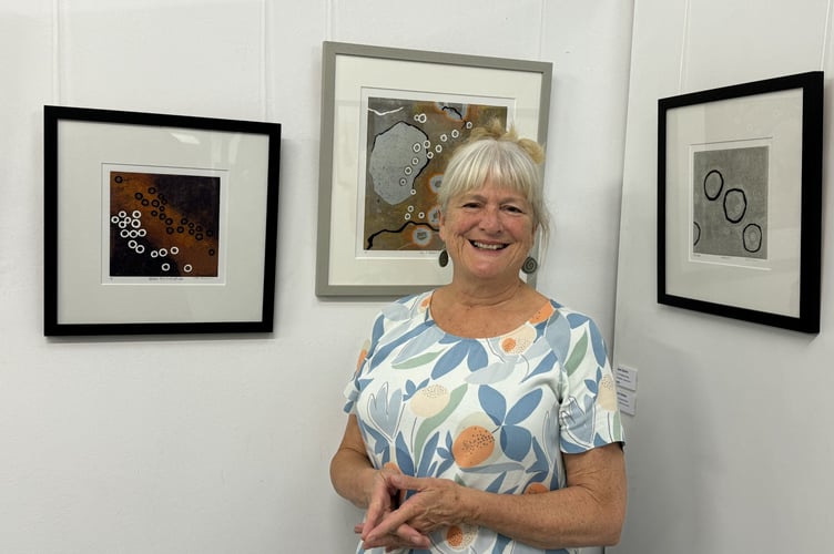 Jess Davies with some of her work from her series based on the ruins of Dartmoor Stone hut circles on display at The White Room in Crediton.  AQ 2210