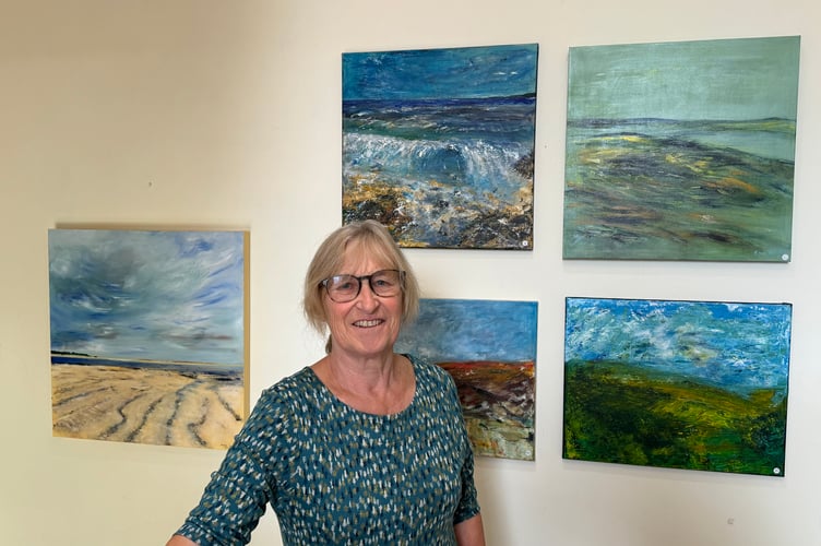 Anne Smith with examples of her paintings. AQ 2515
