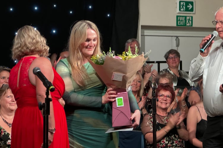 Flowers were presented to Nikki when the second evening concluded. AQ 3723