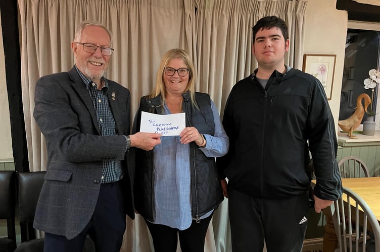 Fred Oliver, President, Crediton Boniface Rotary with Sallie Cartlidge and her son Max, who both volunteer for the Playscheme.
