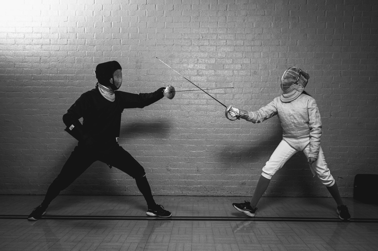 Jason Ball, left, coaching a young female sabre fencer at Heart of Devon Swords