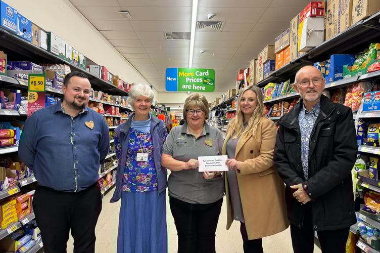 Hazel Evely, centre, presenting the £8,000 from Morrisons Foundation to Chelsea Yelland, Age Concern Crediton operations director with, left, store manager Ben Cooper and Jenny Berg, Age Concern chair and right, trustee Ben Fyfe.  AQ 5073
