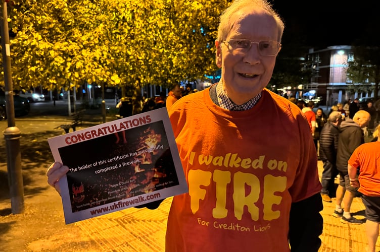 Lion Eric Parkes with his certificate after completing the challenge. AQ 4838