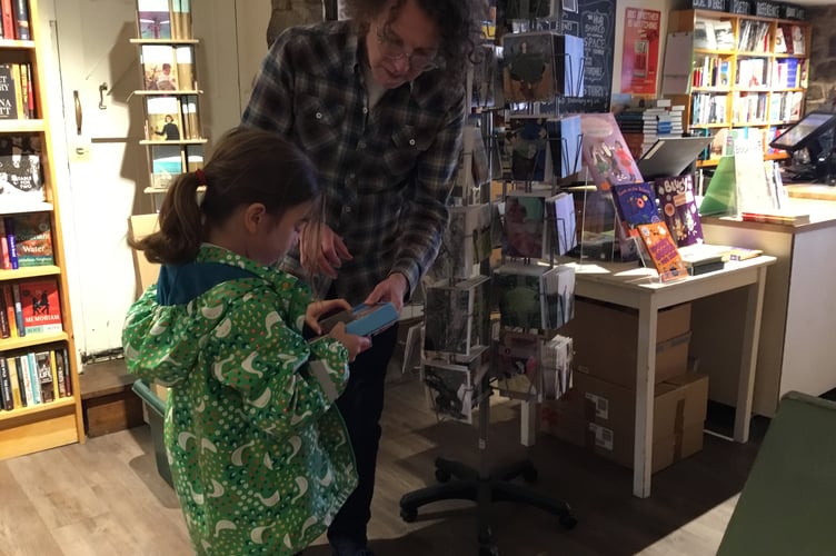 Asking a question about a book at The Bookery.
