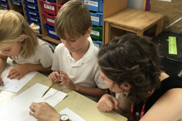 Author Chloe Savage helping pupils at Lapford Community Primary School.
