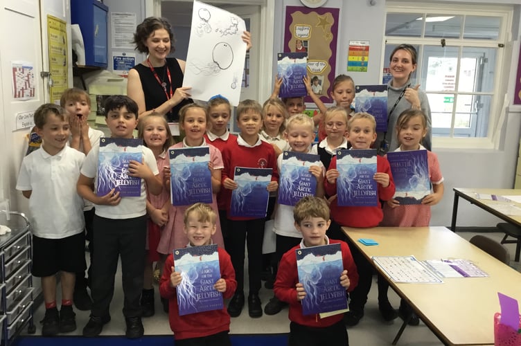 Author Chloe Savage, back left, and pupils at Lapford Primary School with signed copies of her book ‘The Search for the Giant Artic Jellyfish’.