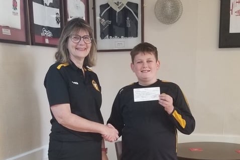 Brennan presenting the cheque to Liz Goodman, chair, Crediton RFC at Crediton Rugby Club.