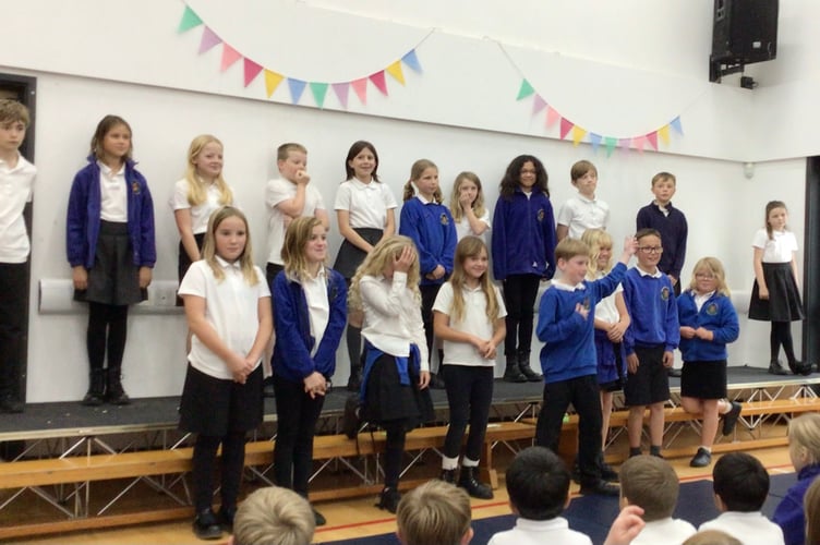 One of the senior classes on stage for the Harvest Festival at Cheriton Fitzpaine Primary School.
