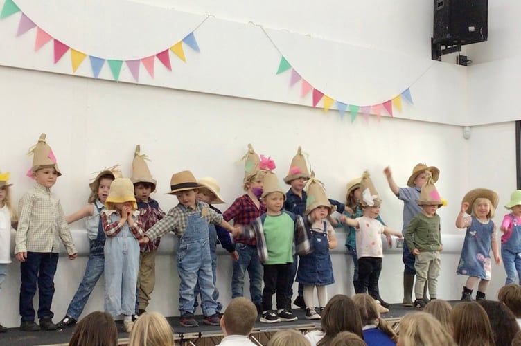 Dressed to sing Dingle Dangle Scarecrow for the Harvest Festival at Cheriton Fitzpaine Primary School.
