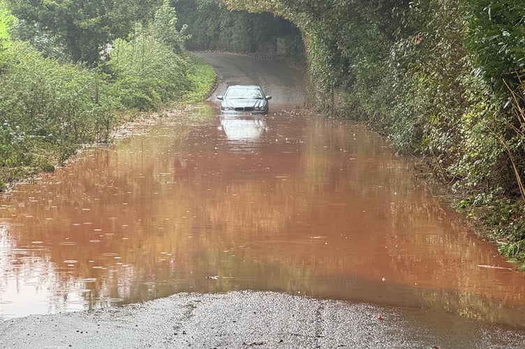 The car stuck in floodwater between Crediton and Sandford. AQ 5427