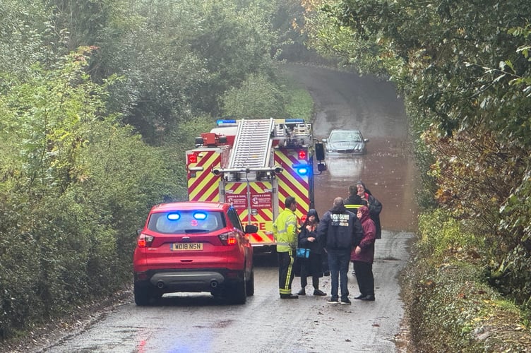 The rescued family talking to firefighters at the scene. AQ 5416