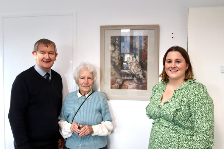From left, Alan Quick, Frankie Peroni, Molly Cooper with owl painting