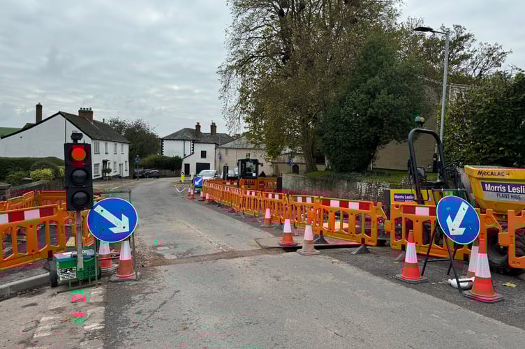 The traffic lights on Jockey Hill and where cones have been placed to prevent vehicles driving down the hole.  AQ 6552
