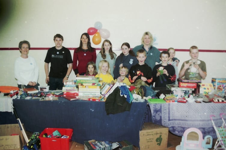 Helpers behind a bring and buy sale stall at Colebrooke were raising funds for the Blue Peter Waterworks Appeal in April 2003. DSC01269