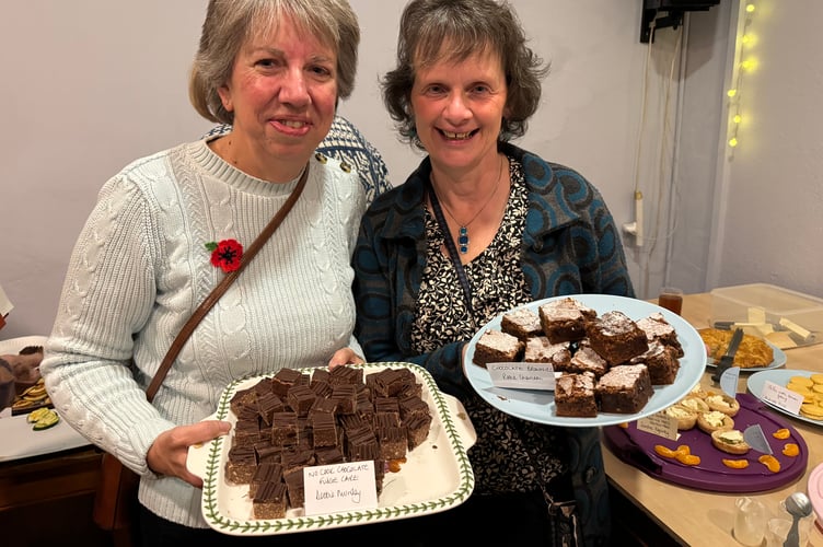Debbie Munday, left, with her No Cook Chocolate Fudge Cake and Rosie Cheriton with her Chocolate Brownies at the ‘A Taste of Sandford’ book launch at The Lamb Inn, Sandford.  AQ 6739