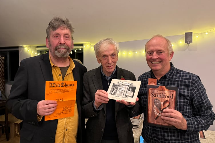 Dr Paul Cleave, centre, spoke at the Sandford Community Cook Book launch, pictured with David Munday, right and left, Stu Wight, manager and postmaster of Sandford Stores, the former proprietor of Wild Thymes, formerly a very popular Crediton Cafe.  AQ 6747