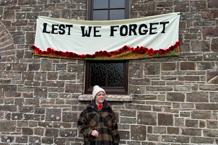 Ashleigh Warman-Dawes with the banner she made for the front of the church.  AQ 7204
