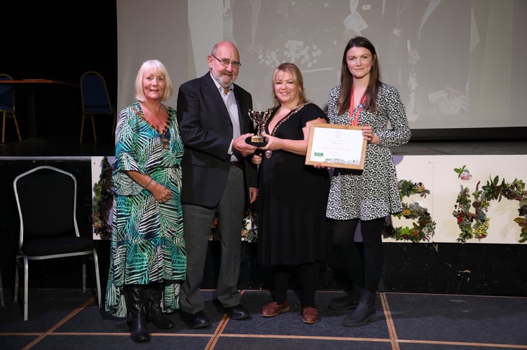 Bert Jewell with the Crediton In Bloom overall Winner in the Pennant Town North and South category certificate, with Emma Anderson, Deputy Clerk, holding the trophy and Silver Gilt Award certificate.
