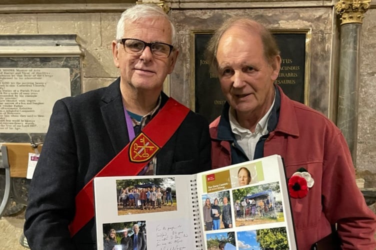 Michael Morpurgo, right, with Sandford Parish Clerk Malcolm Vallance and D-Day 80 scrapbook