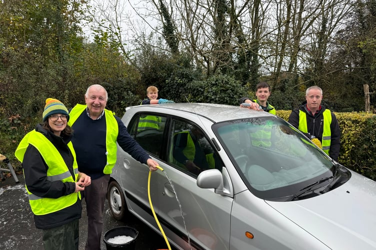 Volunteers cleaning cars in aid of Children in Need at Copplestone Church.  AQ 7790