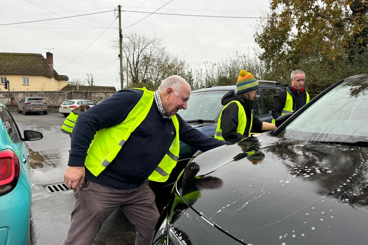 Adults washed cars to help out at Copplestone. AQ 7804