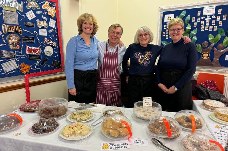 Helpers behind the cake stall at Copplestone Church in aid of Children in Need. AQ 7806