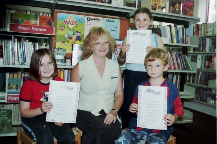 Crediton Library Book Track award recipients, Lucy Northcote, Bethany Dellamuro and Zubin Tucker with Library Assistant Ann Logan in August 2003. SC00261