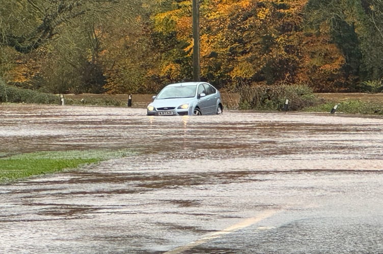 The car stuck in floodwater on the A377 near Ladds, Crediton.  AQ 8504
