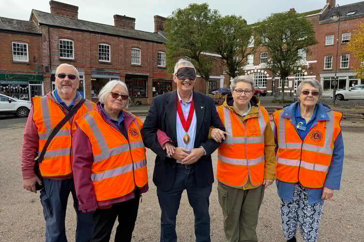 The Mayor of Crediton, Cllr Guy Cochran, centre, during the Lions World Sight Day Challenge with Ann Whitehouse, Crediton Lions President, second left, and other Crediton Lions.  AQ 5166

