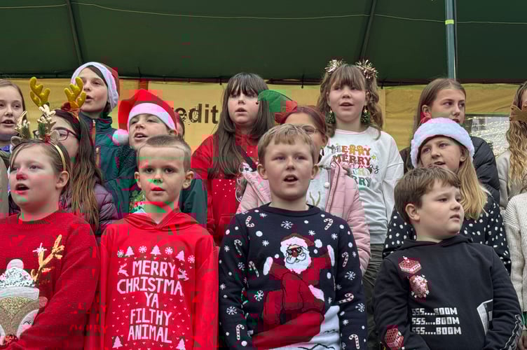 Children singing in the Town Square.  AQ 8878