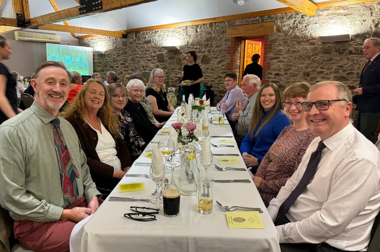 Crediton Town Band Musical Conductor Iorwerth Pugh, left, with some of the band members at the dinner. AQ 7697
