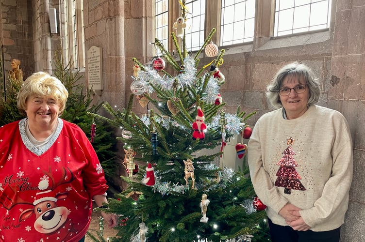 Morrisons Community Champion Hazel Evely, left, and Sandra Williams decorated the Morrisons tree with tinsel, baubles, nutcrackers and more (Will Goddard, Crediton Courier)