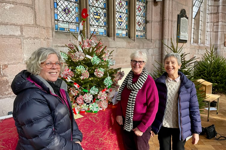 From left, Linda Bennett-Smith, Jean Hope and Mandy Tietze decorated the St Swithun's Church Sandford tree. The decorations are recyclable and were made by the Coffee and Company group at the church (Will Goddard, Crediton Courier)