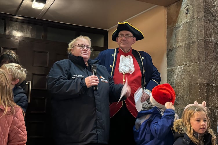 Sarah McKnight, chair, North Tawton Parish Council, during her speech with Town Crier Brendan Cassells. AQ 9545