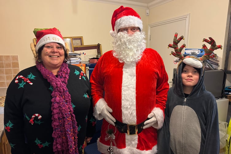 Father Christmas with his helpers before they made their way to the Town Hall steps. AQ 9522