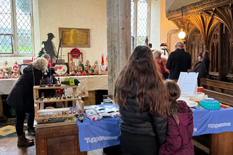 Stalls across the pews in Coldridge Village Hall.  AQ 8366
