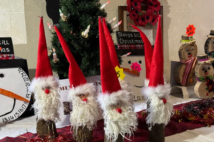 Hand-crafted Santas were for sale. AQ 8369