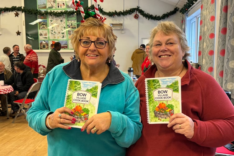 Selling copies of the Bow Village Cookbook. AQ 8312