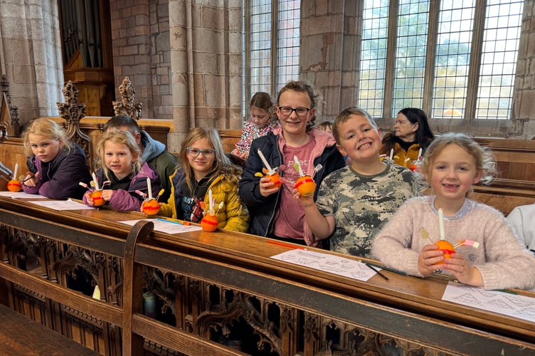 Lots of children with the Christingles they made before the service at Crediton Parish Church.  AQ 0092
