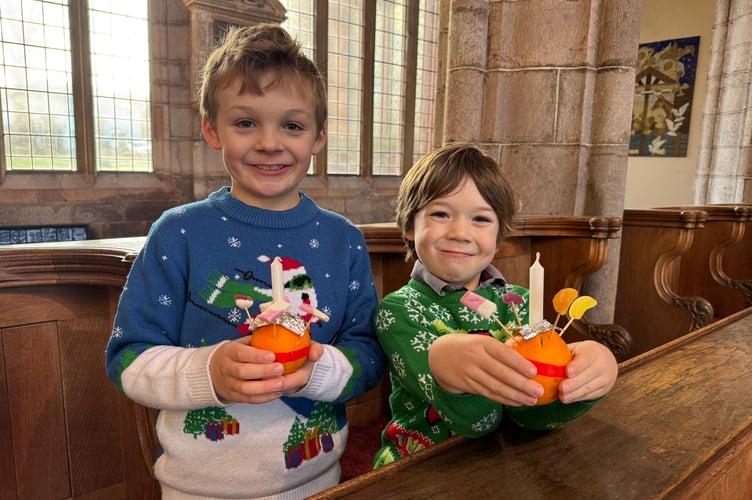 Two proud youngsters with the Christingles they made.  AQ 0078
