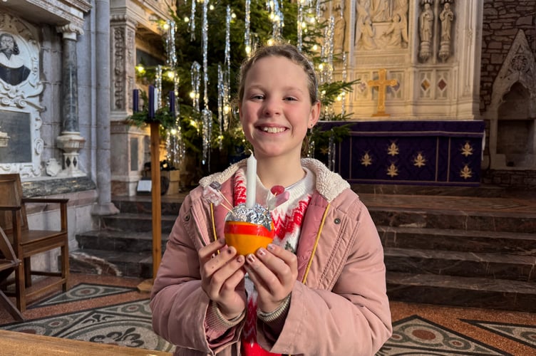 Ivy Doyle with the Christingle she made.  AQ 0095
