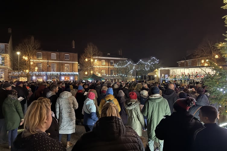 A view of the town band on the lorry and the crowd in front