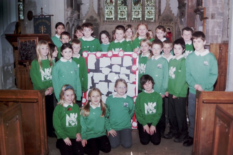 Newton St Cyres School pupils with Remembrance messages at the parish church in November 2003. DSC00320