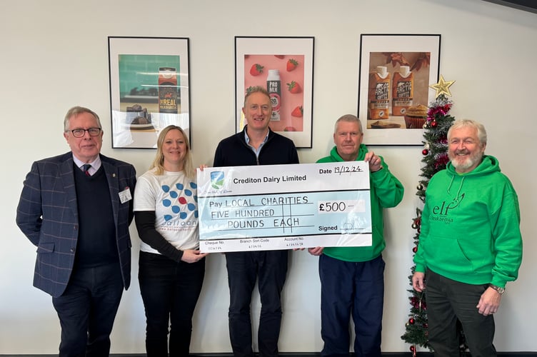 Crediton Dairy finance director Chris Hume, centre, presented charity cheques to, from left, Phil Hutchins from Age Concern Crediton and Nicola Clark from Balloons and right, Andre Pike and Glenn Bearne from ELF.  Not present, Teenage Cancer Trust or Prostate Cancer UK representatives.  AQ 0205