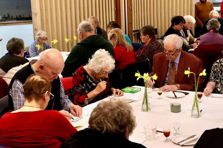 Enjoying playing bingo with a glass of sherry
