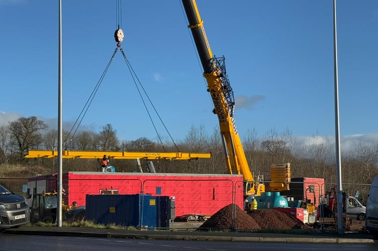 Crane assembling new McDonald's restaurant on site off Joseph Locke Way, Crediton