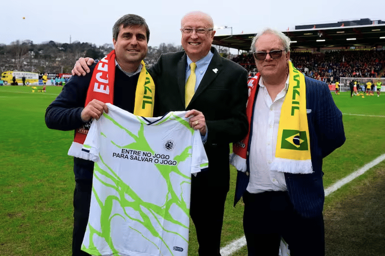 Left to right, Ricardo Calcado from Onda Solidária with Richard Pym, grandson of former city goalkeeper Dick Pym and Nick Hawker, chair of the club and Exeter City Supporters' Trust