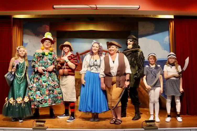 Robinson Crusoe, fourth from left, with other cast members