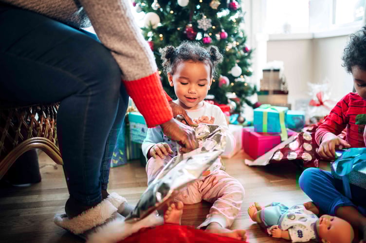 A child receiving a toy donated through the Tesco pre-Christmas toy appeal.
