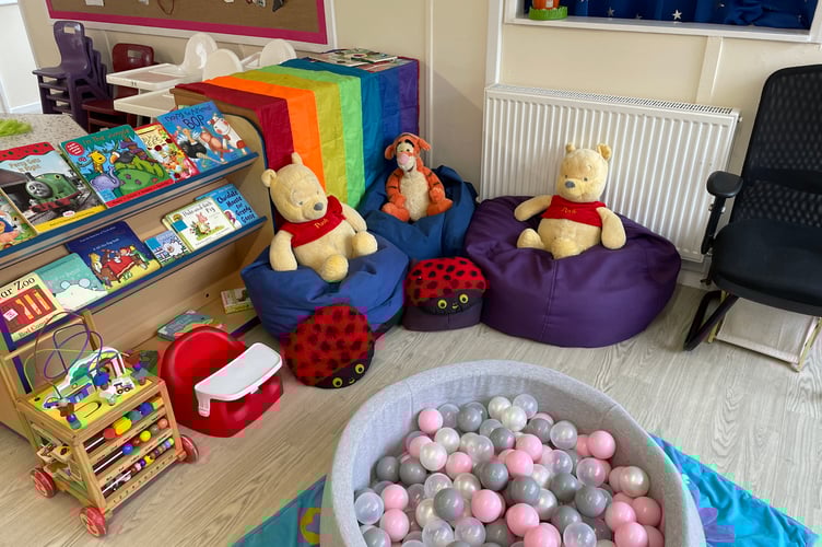 A reading corner featuring books and soft toys